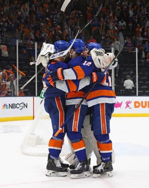 The New York Islanders celebrate after their 3-2 win against the Tampa Bay Lightning after Game Four of the Stanley Cup Semifinals during the 2021...