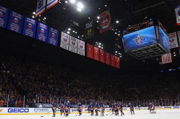 The New York Islanders celebrate after their 3-2 win against the Tampa Bay Lightning after Game Four of the Stanley Cup Semifinals during the 2021...