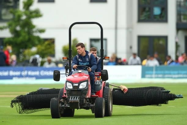 Groundsman carrying the nets off of the pitch prior to the Vitality T20 Blast match between Kent Spitfires and Essex Eagles at The Spitfire Ground on...