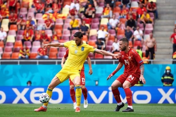 Roman Yaremchuk of Ukraine controls the ball under pressure from Darko Velkovski of North Macedonia during the UEFA Euro 2020 Championship Group C...