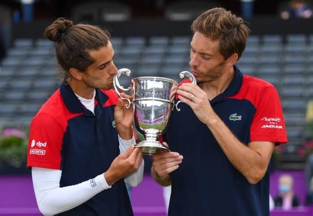 Pierre-Hugues Herbert of France, and Nicolas Mahut of France pose with the trophy after winning the mens doubles finals during Day 7 of The cinch...