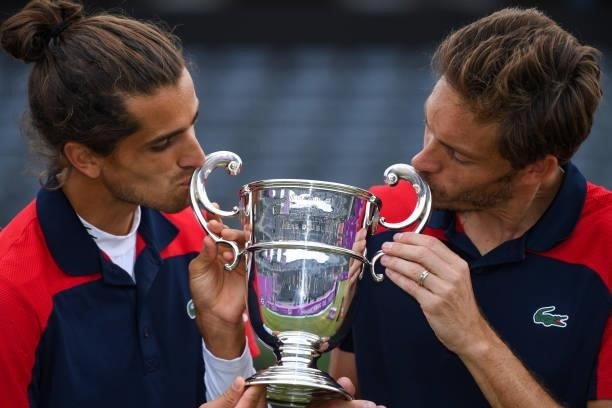 Pierre-Hugues Herbert of France, and Nicolas Mahut of France pose with the trophy after winning the mens doubles finals during Day 7 of The cinch...