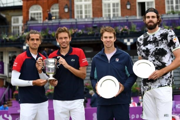 Reilly Opelka of USA, John Peers of Australia, Pierre-Hugues Herbert of France and Nicolas Mahut of France during the trophy presentation after the...
