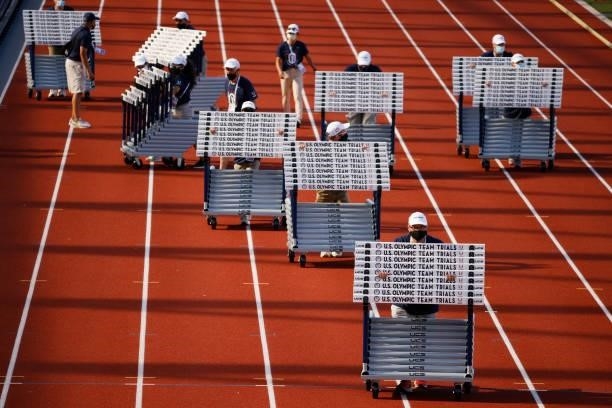 Workers move hurdles on day 2 of the 2020 U.S. Olympic Track & Field Team Trials at Hayward Field on June 19, 2021 in Eugene, Oregon.