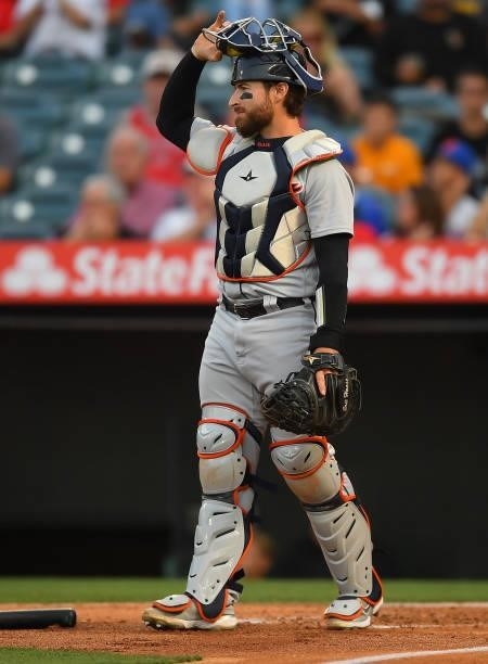 Eric Haase of the Detroit Tigers adjusts his mask in the game against the Los Angeles Angels at Angel Stadium of Anaheim on June 18, 2021 in Anaheim,...