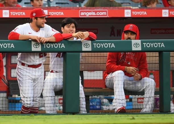 David Fletcher, Shohei Ohtani and Anthony Rendon of the Los Angeles Angels look on from the dugout during the game against the Detroit Tigers at...
