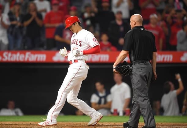 Shohei Ohtani of the Los Angeles Angels touches home plate after hitting a home run in the eighth against the Detroit Tigers at Angel Stadium of...