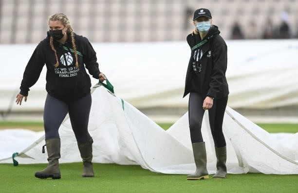 Groundstaff take covers from the field before Day 3 of the ICC World Test Championship Final between India and New Zealand at The Hampshire Bowl on...