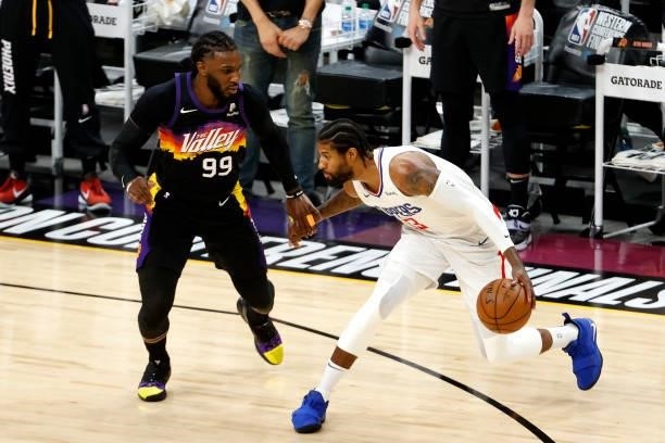 Paul George of the Los Angeles Clippers dribbles against Jae Crowder of the Phoenix Suns in the first quarter during game one of the Western...