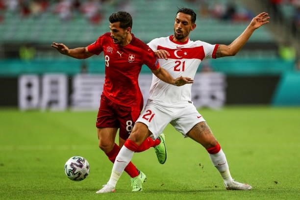 Irfan Can Kahveci of Turkey fights for the ball with Remo Freuler of Switzerland during the UEFA Euro 2020 Championship Group A match between...