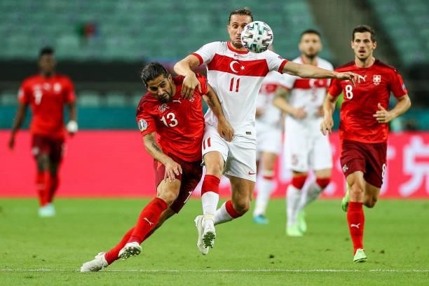 Yusuf Yazc of Turkey fights for the ball with Ricardo Rodríguez of Switzerland during the UEFA Euro 2020 Championship Group A match between...