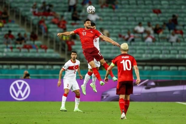 Okay Yokulu of Turkey fights for the ball with Loris Benito of Switzerland during the UEFA Euro 2020 Championship Group A match between Switzerland...