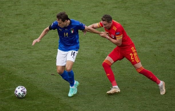 Federico Chiesa of Italy competes for the ball with Chris Gunter of Wales during the UEFA Euro 2020 Championship Group A match between Italy and...