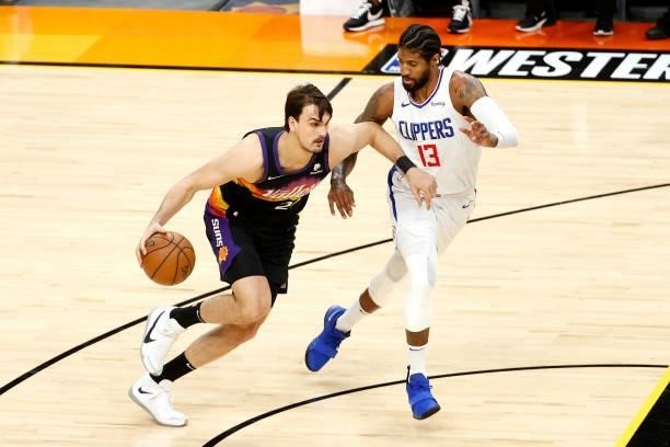 Dario Saric of the Phoenix Suns handles the ball against Paul George of the Los Angeles Clippers in the first quarter during game one of the Western...
