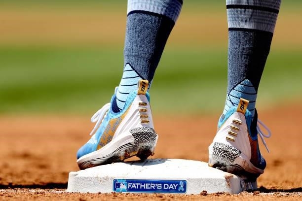 Detail of the shoes worn by Raimel Tapia of the Colorado Rockies as he stands on first base after hitting a single against the Milwaukee Brewers in...