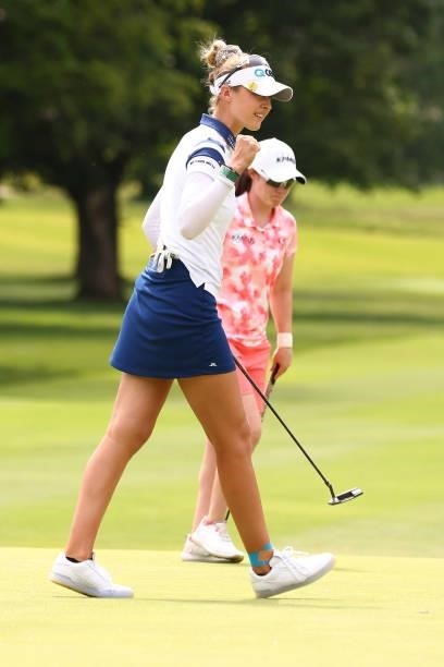 Nelly Korda celebrates winning the Meijer LPGA Classic for Simply Give with a birdie on the 18th green in front of Leona Maguire of Ireland at...