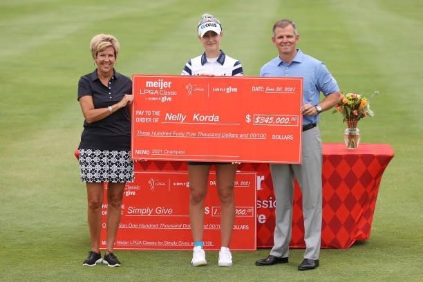 Nelly Korda poses with the winners check after winning the Meijer LPGA Classic for Simply Give at Blythefield Country Club on June 20, 2021 in Grand...