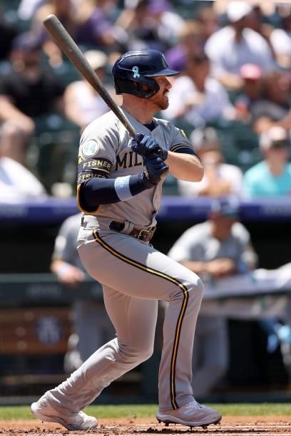Derek Fisher of the Milwaukee Brewers hits a RBI single against the Colorado Rockies in the first inning at Coors Field on June 20, 2021 in Denver,...