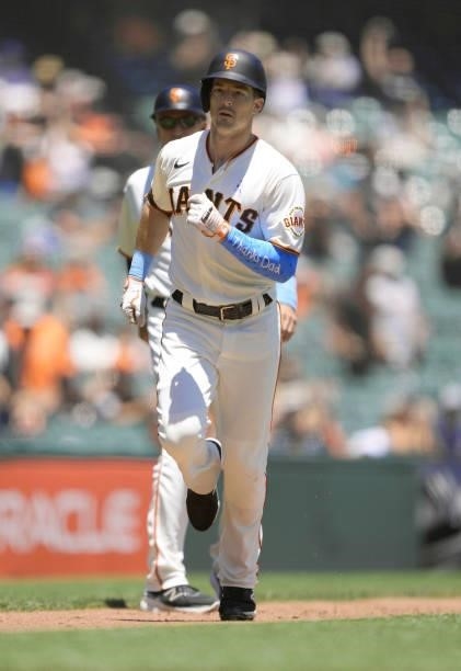 Mike Yastrzemski of the San Francisco Giants trots around the bases after hitting a two-run home run while wearing a sleeve that read "Thanks Dad