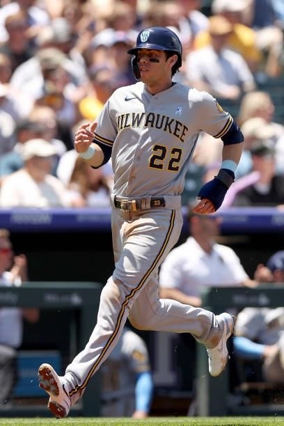 Christian Yelich of the Milwaukee Brewers scores on a single hit by Derek Fisher against the Colorado Rockies in the first inning at Coors Field on...
