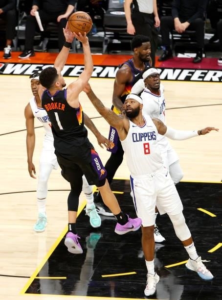 Devin Booker of the Phoenix Suns shoots against Marcus Morris Sr. #8 of the Los Angeles Clippers in the second quarter during game one of the Western...