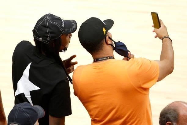 Fan takes a selfie with NFL player DeAndre Hopkins of the Arizona Cardinals during game one of the Western Conference Finals between the Phoenix Suns...