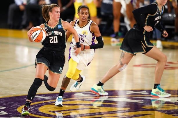 Guard Sabrina Ionescu of the New York Liberty handles the ball defended by guard Brittney Sykes of the Los Angeles Sparks in the first half at Los...