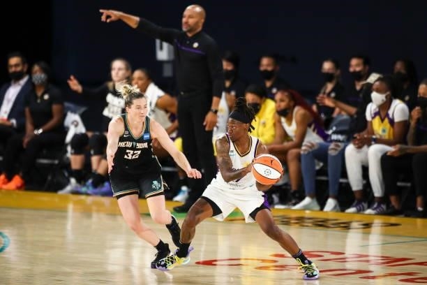 Guard Erica Wheeler of the Los Angeles Sparks handles the ball while defended by guard Sami Whitcomb of the New York Liberty in the first half at Los...