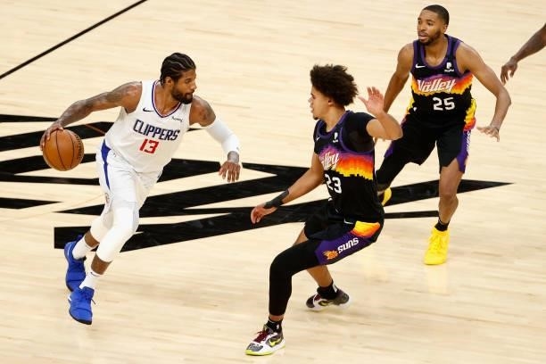 Paul George of the LA Clippers handles the ball against Cameron Johnson of the Phoenix Suns during the second half of game one of the Western...