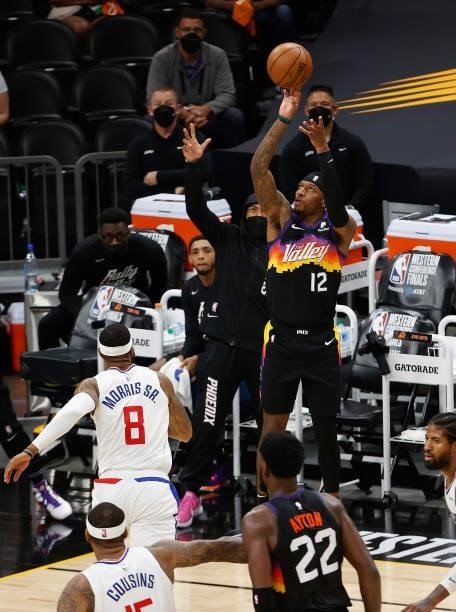 Torrey Craig of the Phoenix Suns puts up a three-point shot over Marcus Morris Sr. #8 of the LA Clippers during the second half of game one of the...