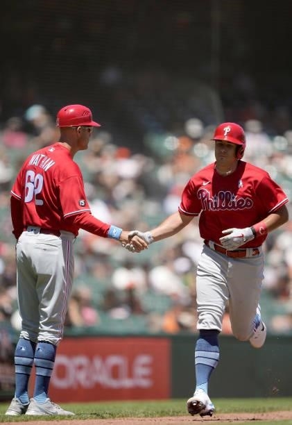 Realmuto of the Philadelphia Phillies is congratulated by third base coach Dusty Wathan after Realmuto hit a two-run home run against the San...