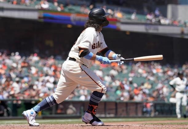Brandon Crawford of the San Francisco Giants watches the flight of his ball as he hits a two-run home run against the Philadelphia Phillies in the...