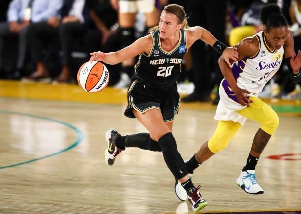 Guard Sabrina Ionescu of the New York Liberty handles the ball ahead of guard Brittney Sykes of the Los Angeles Sparks in the first half at Los...