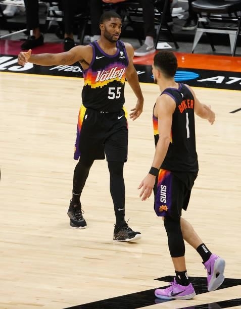 Twaun Moore of the Phoenix Suns high fives Devin Booker after scoring against the LA Clippers during the second half of game one of the Western...