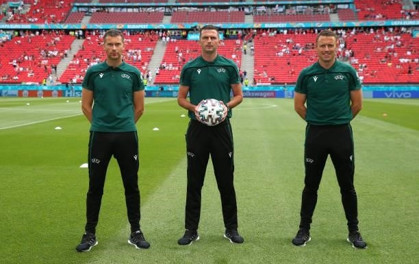 Referee Michael Oliver stands alongside his assistant referees, Stuart Burt and Simon Bennett, for a photograph prior to the UEFA Euro 2020...