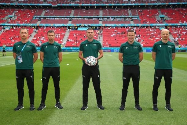 Referee Michael Oliver stands alongside his assistants for a photograph prior to the UEFA Euro 2020 Championship Group F match between Hungary and...