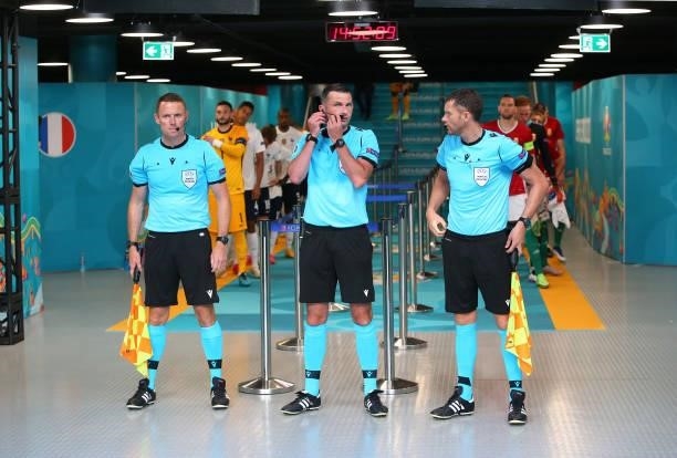 Referee Michael Oliver waits alongside his assistant referees, Stuart Burt and Simon Bennett, in the tunnel prior to the UEFA Euro 2020 Championship...