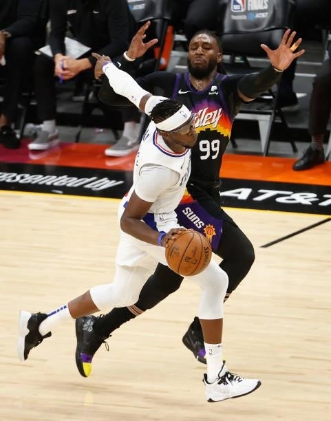 Reggie Jackson of the LA Clippers moves the ball against Jae Crowder of the Phoenix Suns during the second half of game one of the Western Conference...