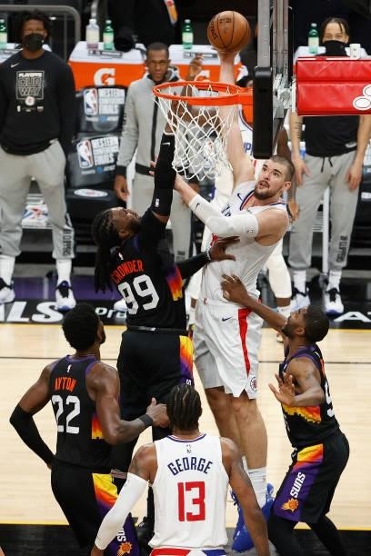 Ivica Zubac of the LA Clippers puts up a shot over Jae Crowder of the Phoenix Suns during the second half of game one of the Western Conference...