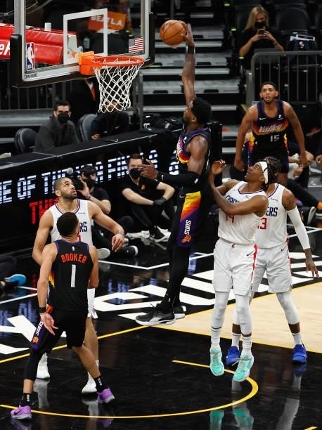 Deandre Ayton of the Phoenix Suns slam dunks the ball ahead of Terance Mann of the LA Clippers during the second half of game one of the Western...