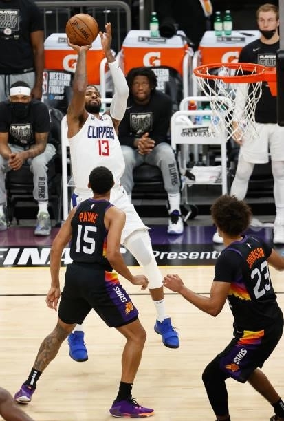 Paul George of the LA Clippers attempts a shot over Cameron Payne of the Phoenix Suns during the second half of game one of the Western Conference...