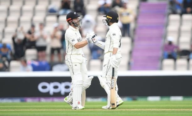 Kane Williamson congratulates Devon Conway of New Zealand after he scores 50 runs during Day 3 of the ICC World Test Championship Final between India...