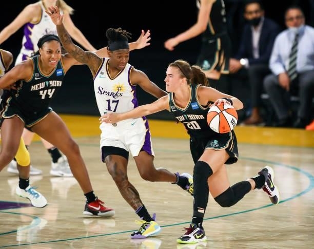 Guard Sabrina Ionescu of the New York Liberty handles the ball defended by guard Erica Wheeler of the Los Angeles Sparks during the second half at...