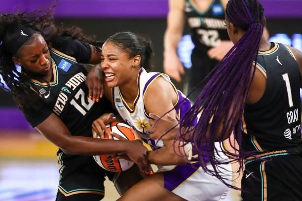 Forward/center Kristine Anigwe of the Los Angeles Sparks handles the ball defended by forward Michaela Onyenwere of the New York Liberty at Los...