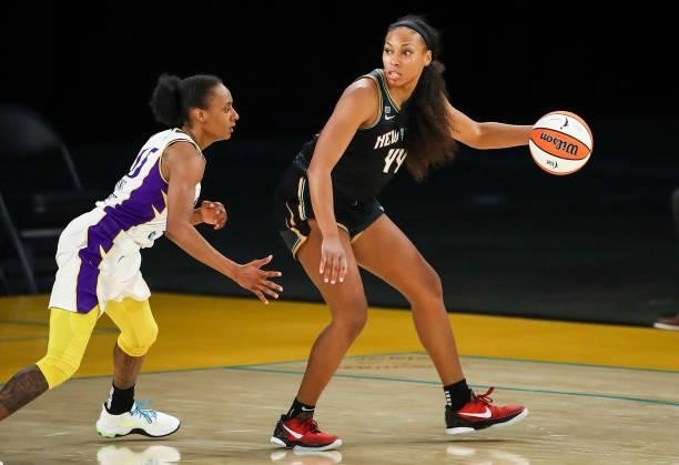 Guard/forward Betnijah Laney of the New York Liberty handles the ball defended by guard Brittney Sykes of the Los Angeles Sparks at Los Angeles...