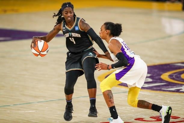 Guard Jazmine Jones of the New York Liberty handles the ball defended by guard Brittney Sykes of the Los Angeles Sparks at Los Angeles Convention...