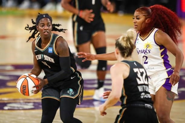 Guard Jazmine Jones of the New York Liberty handles the ball defended by guard Te'a Cooper of the Los Angeles Sparks at Los Angeles Convention Center...