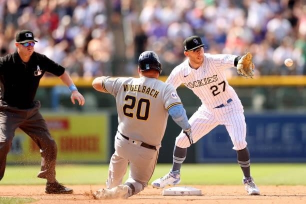 Daniel Vogelbach of the Milwaukee Brewers is out at second base by Trevor Story of the Colorado Rockies aftre trying to stretch a single into a...