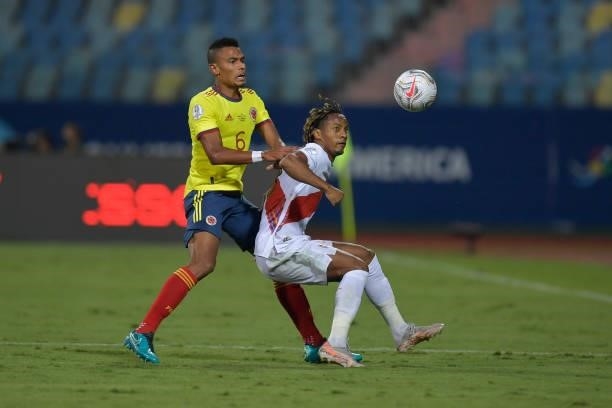 William Tesillo of Colombia competes for the ball with André Carrillo of Peru during a group b match between Colombia and Peru as part of Copa...