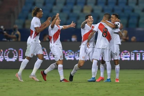 Sergio Peña of Peru celebrates with teammates after scoring the first goal of his team during a group b match between Colombia and Peru as part of...